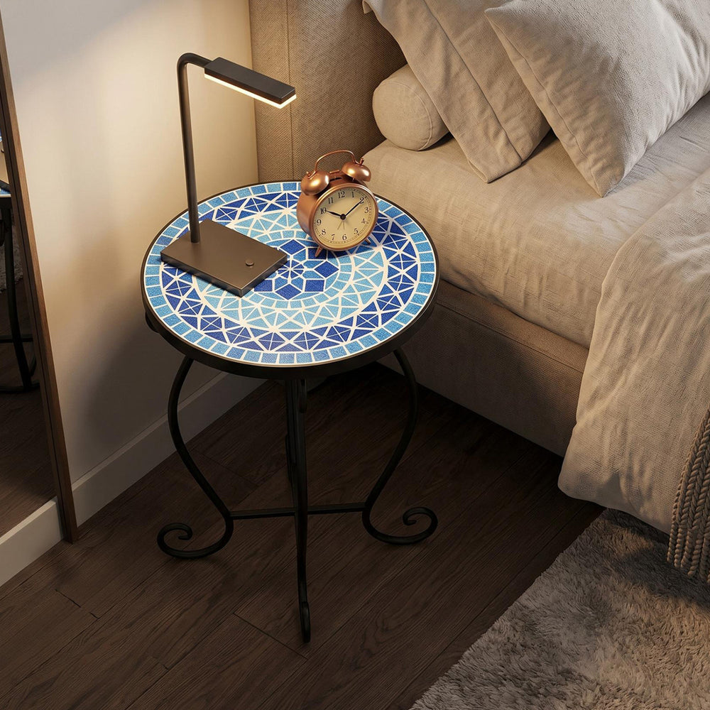 Round accent table with cobalt blue mosaic top and black steel frame, ideal for indoor or outdoor use as a plant stand.
