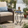 Round cobalt blue mosaic accent table with black steel frame, perfect for plants or drinks in indoor or outdoor settings.