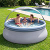 Outdoor inflatable pool with sunshade canopy, accommodating 4-6 adults, ideal for backyard summer fun and relaxation.