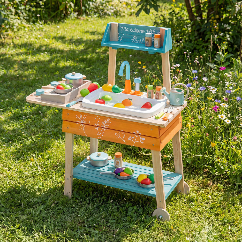 Wooden outdoor kids play kitchen set in orange with removable sink, featuring colorful food items and accessories.