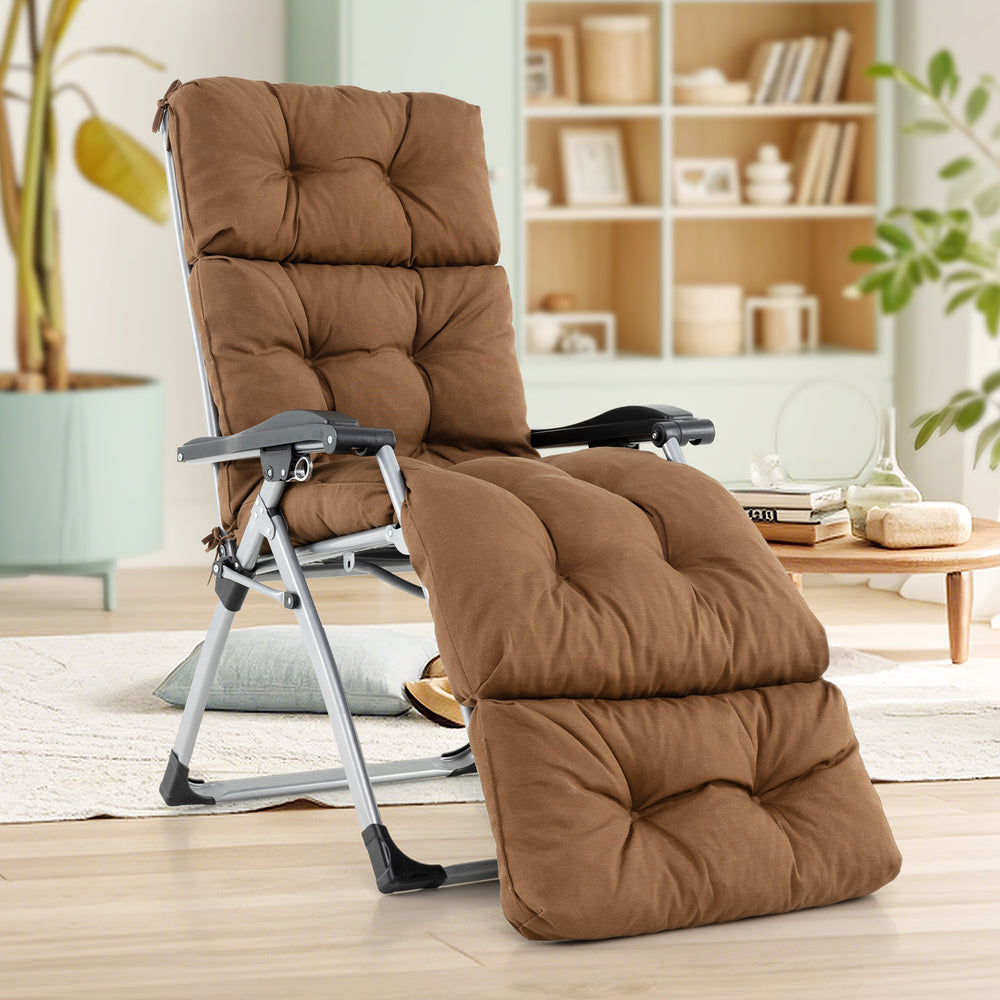 Brown outdoor lounge chaise cushion with string ties, showcasing tufted design for stylish comfort by the poolside.