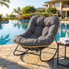 Outdoor Papasan rocking chair with thick gray cushion, ergonomic design, perfect for patio relaxation by the pool.