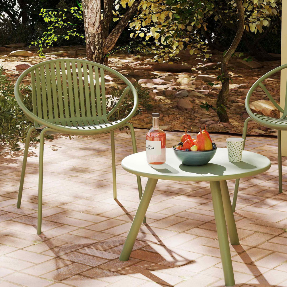 Green outdoor chair and coffee table from the Outdoor Paradise 7-Piece Patio Relaxation Set, perfect for garden.