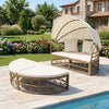 Outdoor patio daybed with retractable canopy and white cushions, made of yellow wicker rattan for garden relaxation.