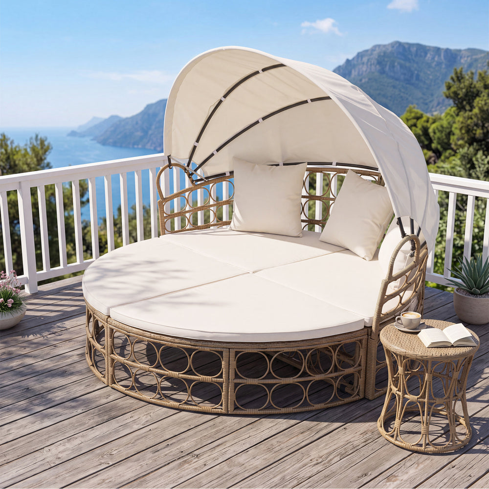 Round outdoor patio daybed with a retractable canopy, yellow wicker rattan, and plush cushions, perfect for balcony lounging.