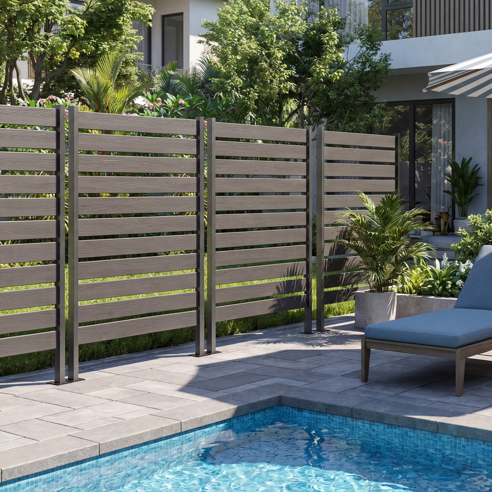 Gray outdoor privacy screen fence with slatted panel design for backyard pool and lawn, ensuring airflow and privacy.