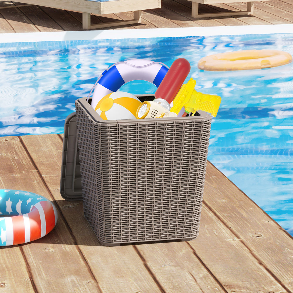 Wicker-woven outdoor resin storage side table with removable lid, filled with pool supplies, ideal for patio or garden.