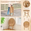 Folding outdoor side table made of solid acacia wood with slatted tabletop and X-shaped structure for stability.