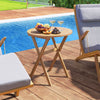 Outdoor side table with slatted tabletop, made of solid acacia wood, perfect for poolside relaxation and easy storage.