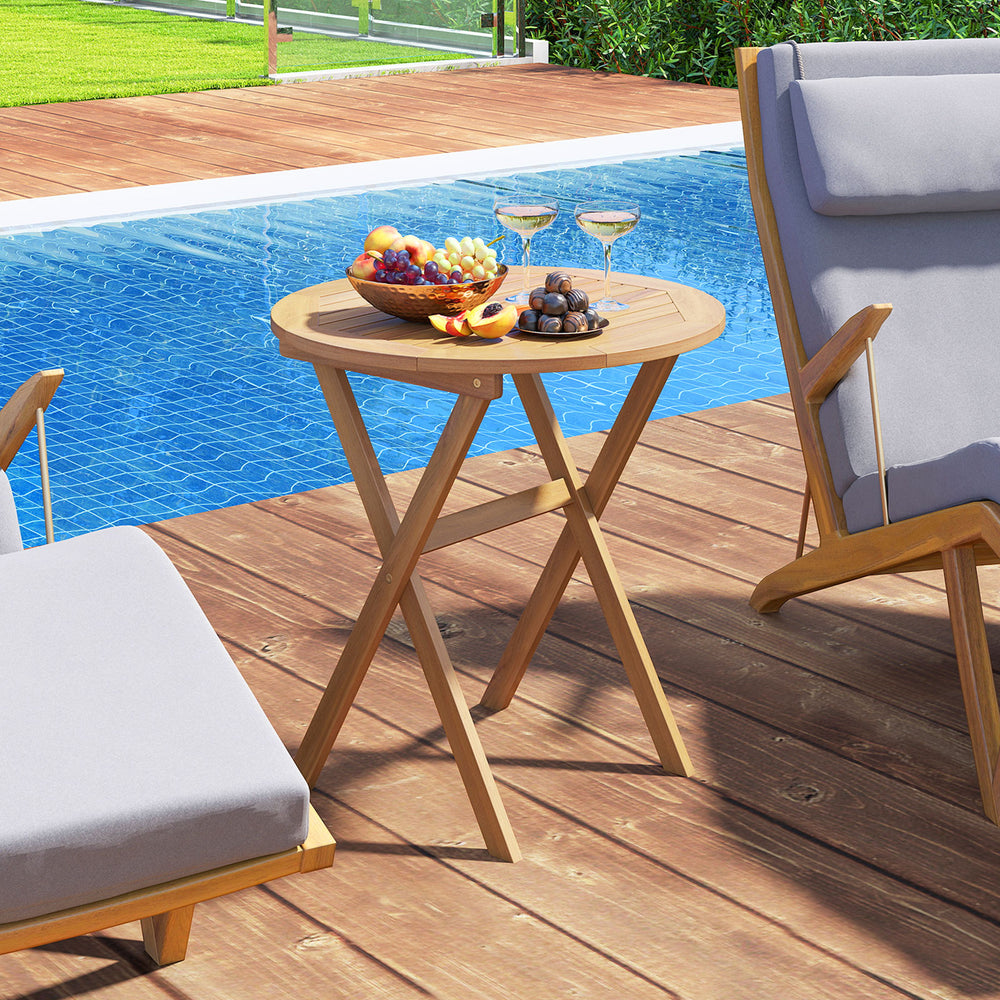 Outdoor side table with slatted tabletop, made of solid acacia wood, perfect for poolside relaxation and easy storage.