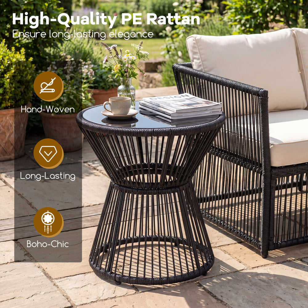 Outdoor side table in black with tempered glass top, featuring hand-woven PE rattan for a boho-chic look, ideal for.