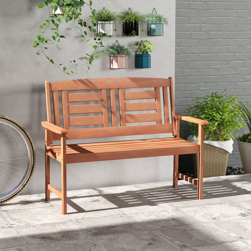 Outdoor hardwood loveseat bench showcasing smooth finish and slatted design, ideal for enhancing garden and patio.