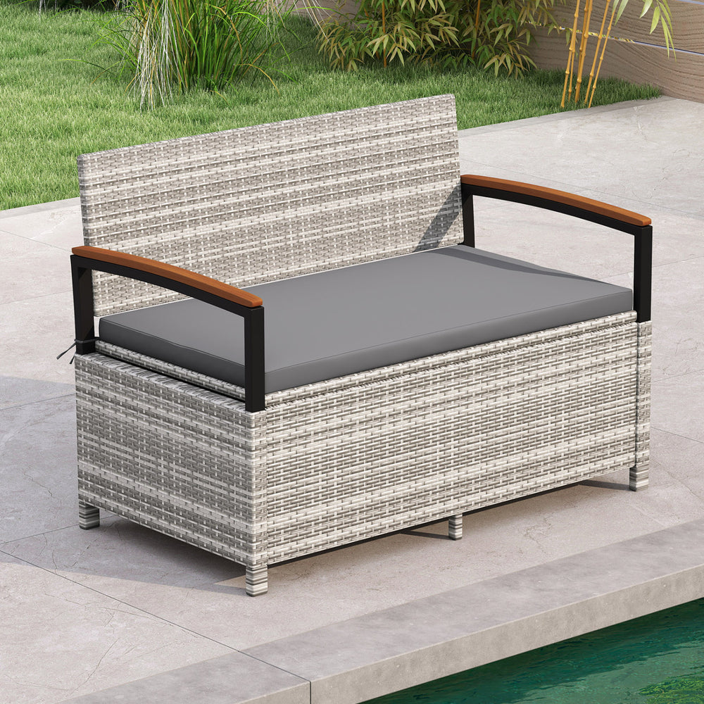 Outdoor storage bench with gray cushion, made of anti-fading PE rattan, ideal for patio or poolside seating.