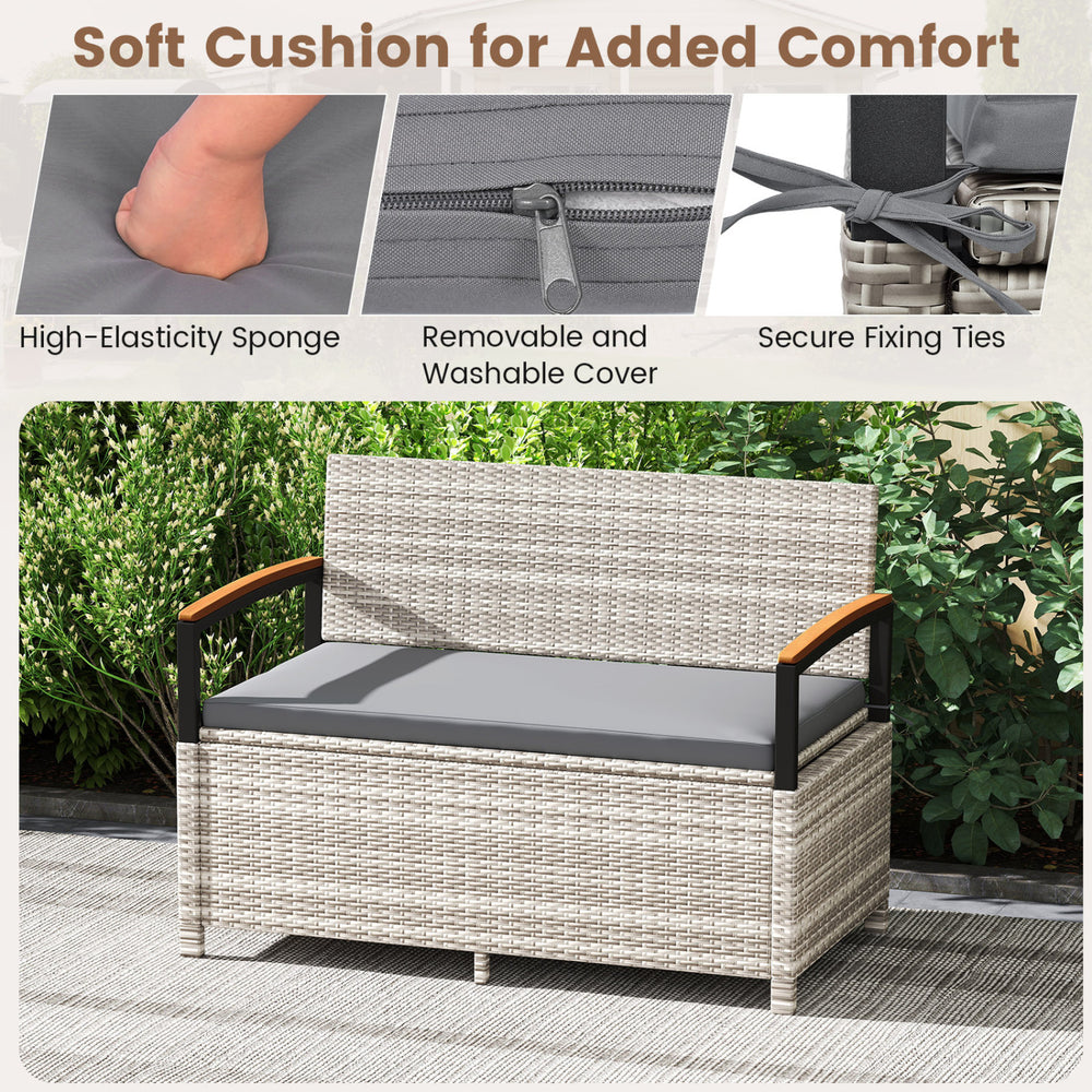 Outdoor storage bench with gray cushion, featuring PE rattan, acacia wood armrests, and waterproof liner for patio use.
