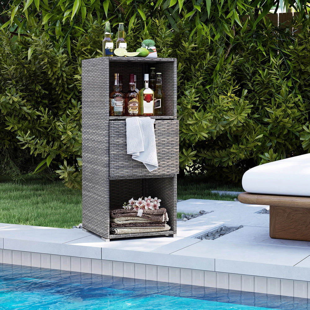 Outdoor storage cabinet in gray wicker with three shelves and a removable drawer, perfect for poolside organization.