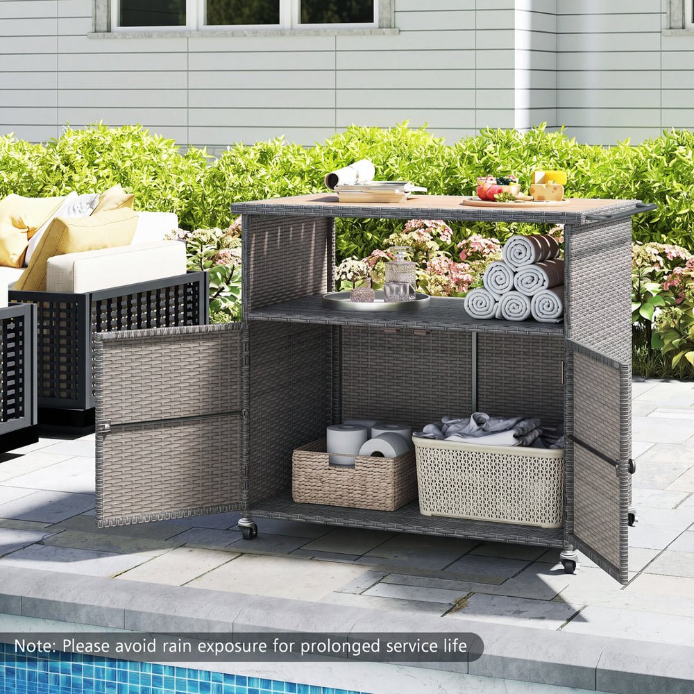 Outdoor storage cabinet with acacia wood top and lockable wheels, featuring PE rattan for patio organization and durability.