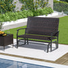 Outdoor 2-person swing glider bench with brown rattan surface and quick dry foam seat, perfect for poolside relaxation.