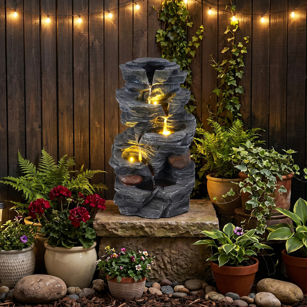 5-tier outdoor water fountain with LED lights, cascading rock design, and durable resin construction for a calming.