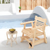 Outdoor wood rocking chair with high back and widened armrests, placed poolside for a rustic touch and comfort.