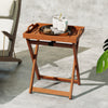 Portable outdoor wood tray table with folding frame and removable tray, perfect for serving in patio or garden settings.