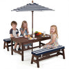 Kids enjoying snacks at the outdoor wooden picnic table with removable umbrella and blue cushions for fun dining.