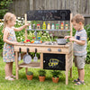 Wooden outdoor mud kitchen for kids featuring stoves, sinks, storage, and blackboards for imaginative play and.