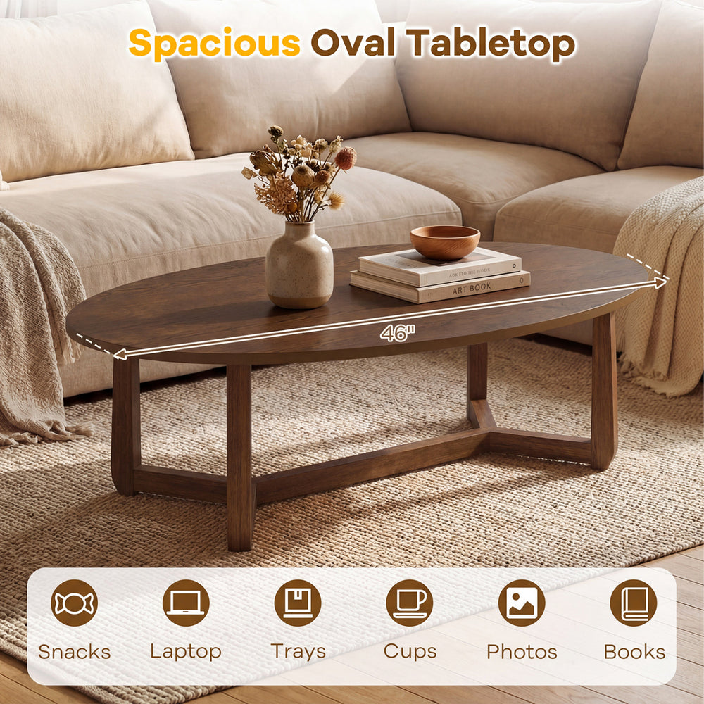 Oval coffee table with a thickened walnut top, measuring 46 inches, perfect for snacks and laptops in a cozy living.