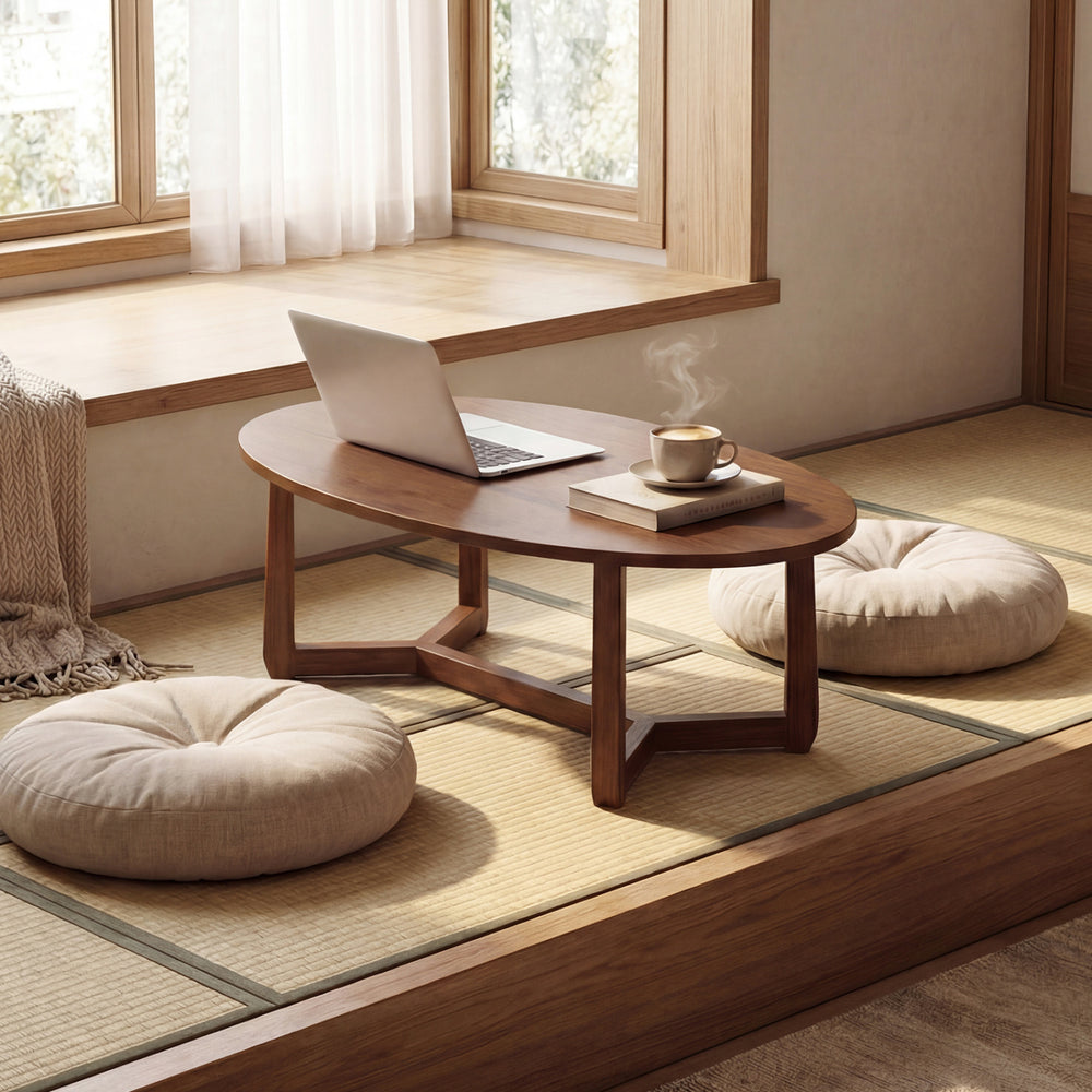 Oval coffee table with a thickened walnut top, featuring a V-shaped base, perfect for snacks and laptops in a cozy.