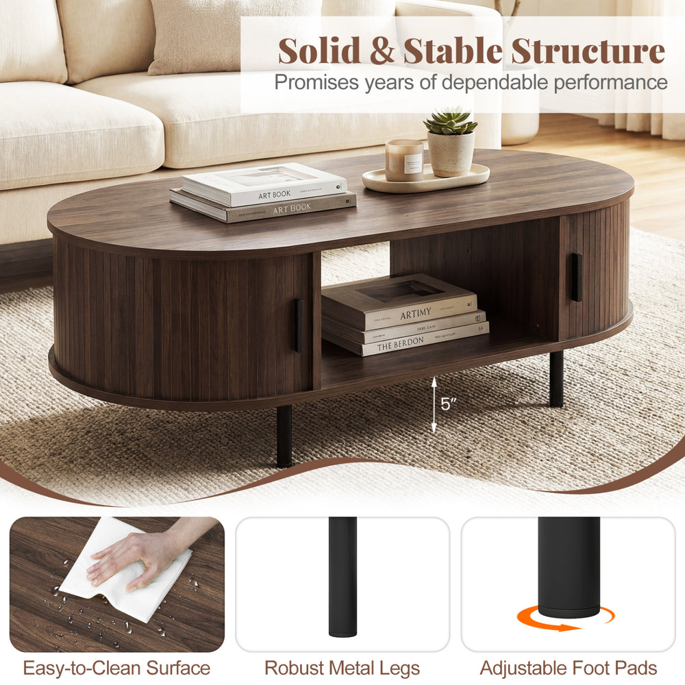 Oval coffee table with walnut finish, featuring dual side shelves and robust metal legs, perfect for stylish living.