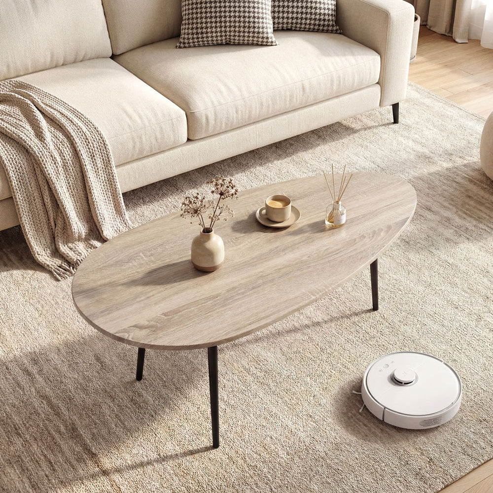 Oval coffee table with sturdy metal construction in gray, featuring elegant edges and perfect for living room.