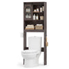 Over toilet storage cabinet in oak with sliding barn door, open shelves, and hooks for towels and toilet paper.