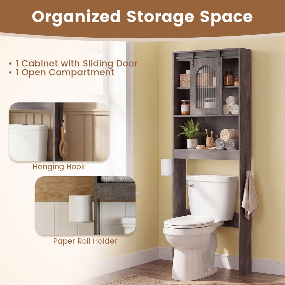 Over toilet storage cabinet in oak with sliding barn door, open shelves, and hooks for organized bathroom essentials.