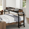 Overbed desk with wheels in brown, adjustable height for queen size beds, ideal for working, reading, or gaming.