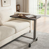 Overbed table with walnut finish, lockable rolling wheels, and sturdy H-shaped base for home or hospital use.