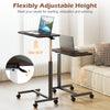Overbed table with a walnut finish, adjustable height from 29" to 42.5", featuring lockable rolling wheels for stability.