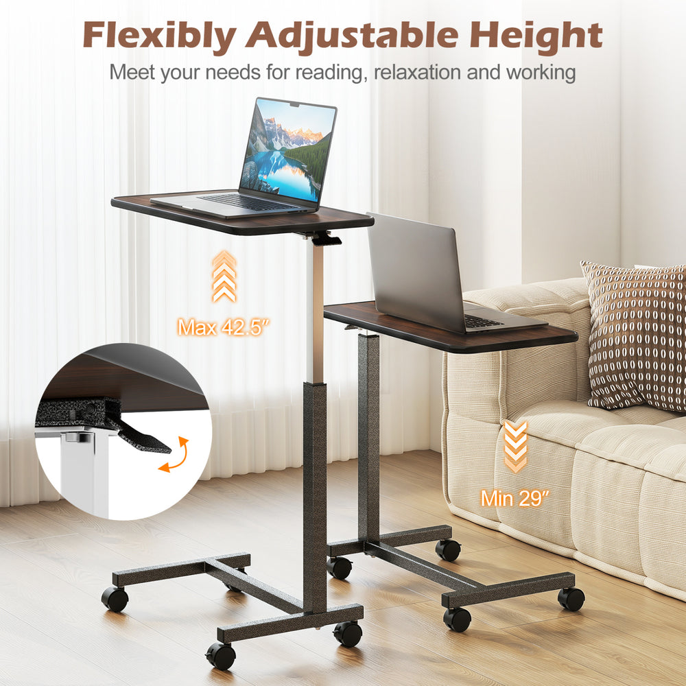 Overbed table with a walnut finish, adjustable height from 29" to 42.5", featuring lockable rolling wheels for stability.