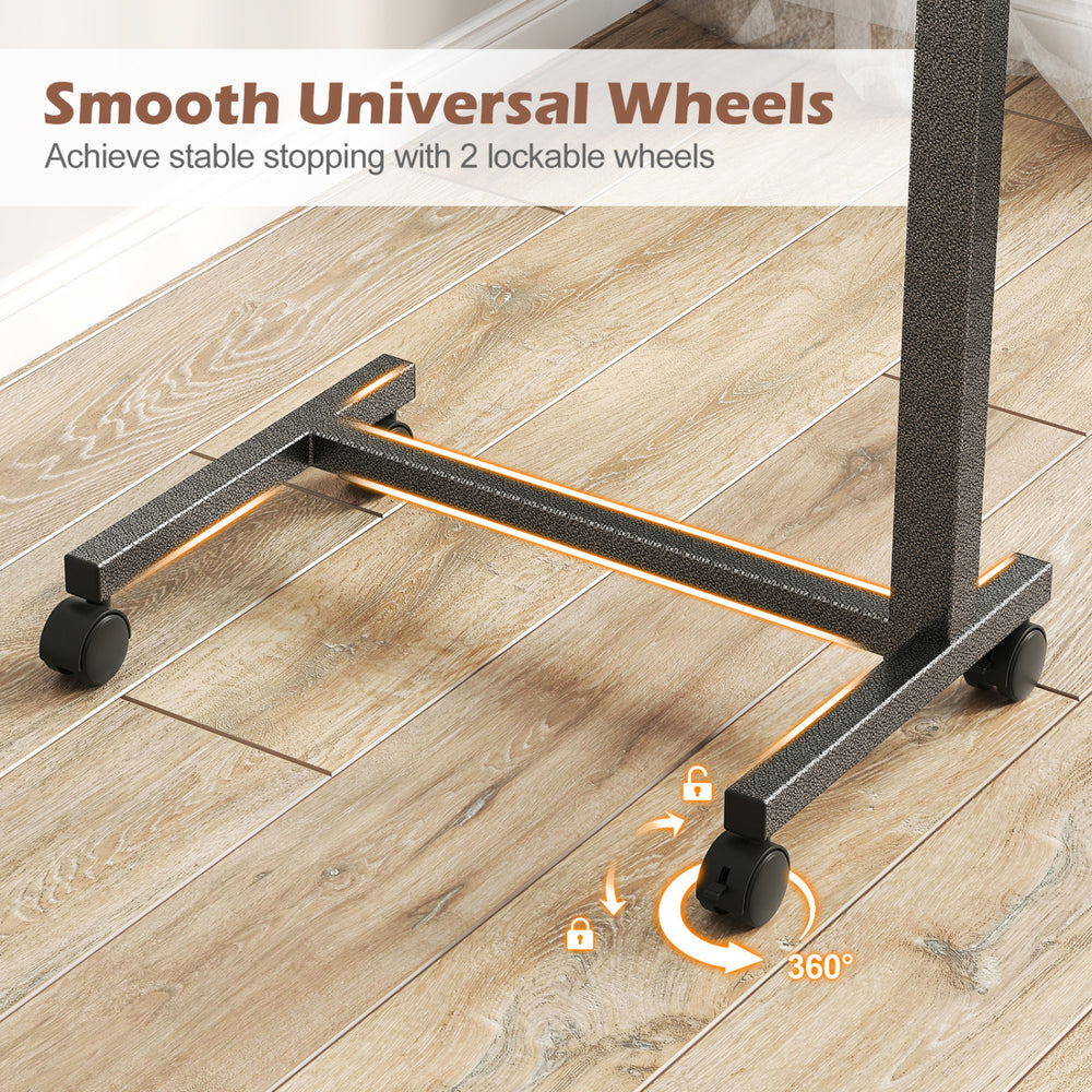 Overbed table features lockable rolling wheels and a sturdy H-shaped base, ideal for home and hospital use.