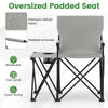 Oversized camping chair in gray with padded armrests, side table, and storage pockets, ideal for outdoor relaxation.