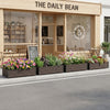 Large PE rattan raised garden bed with removable liner, perfect for planting flowers and herbs on patios or balconies.