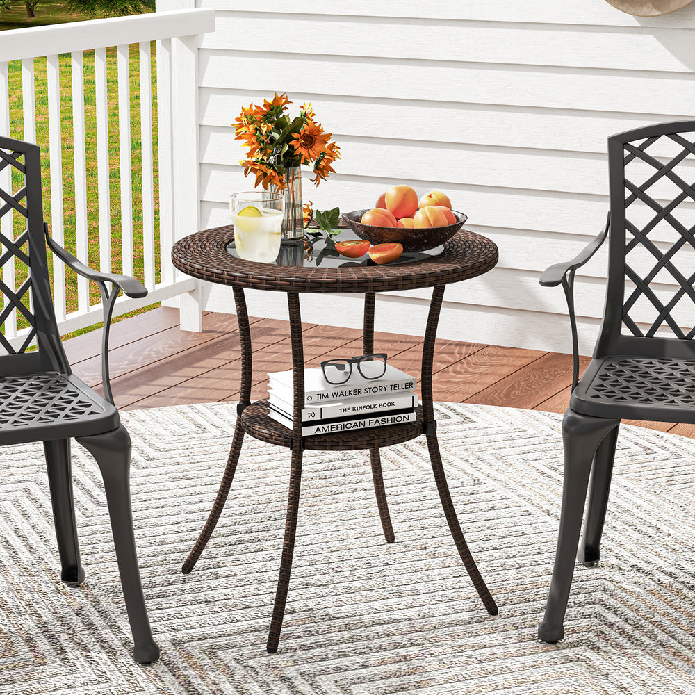 Round PE wicker patio bistro table with a stylish tempered glass top, perfect for drinks and snacks on the porch.
