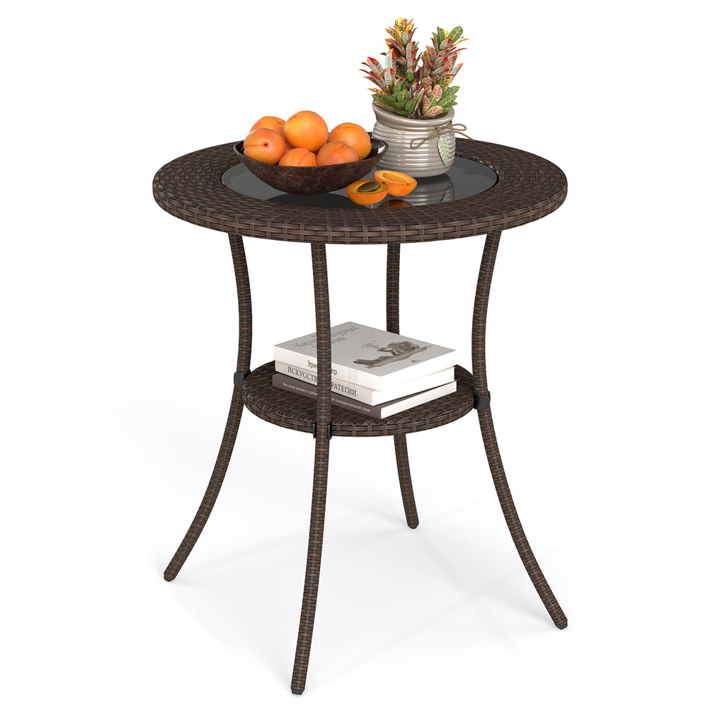 Round PE wicker patio bistro table with tempered glass top and shelf, ideal for outdoor use on balcony or garden.
