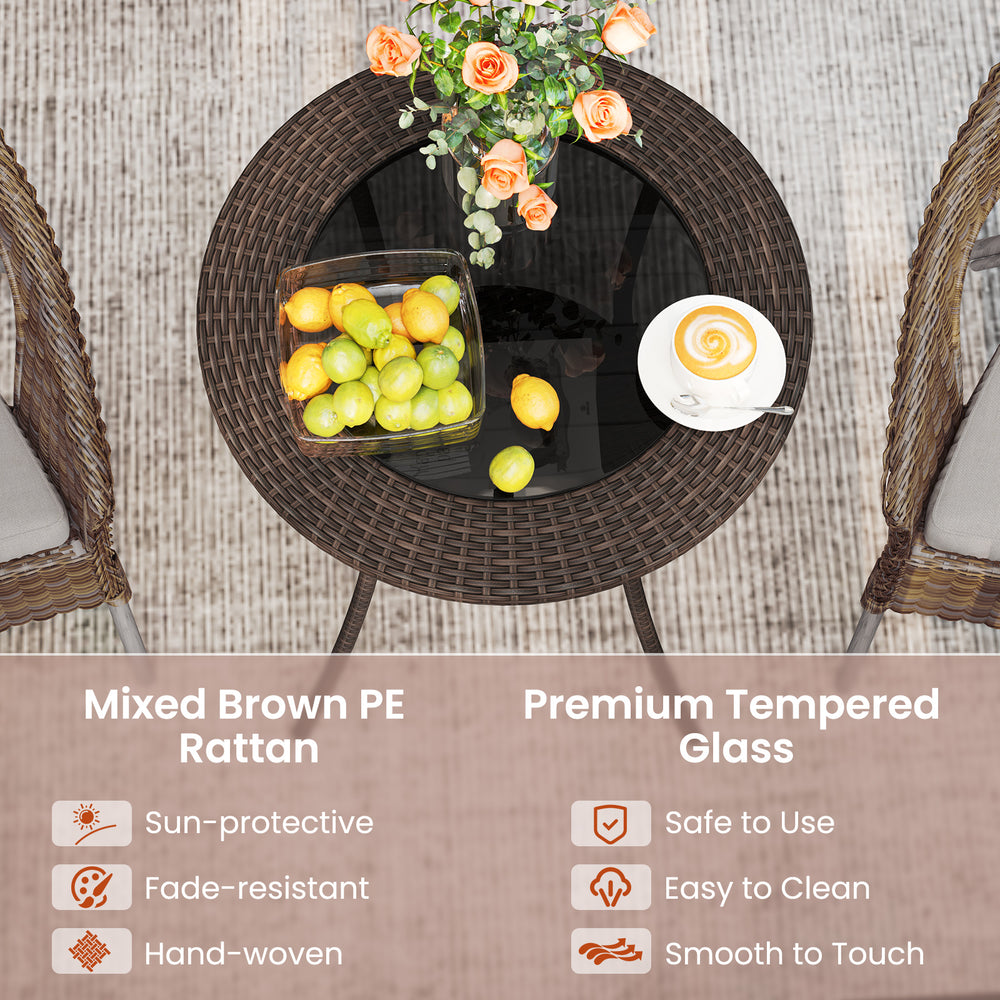 Round PE wicker patio bistro table with tempered glass top, featuring hand-woven brown rattan for outdoor use.