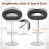 Height-adjustable black bar stool set with hollow back, footrest, and 360-degree swivel for personalized comfort.