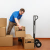 P-handle hand truck with foldable load plate, ideal for moving boxes in warehouses or garages, shown in use.