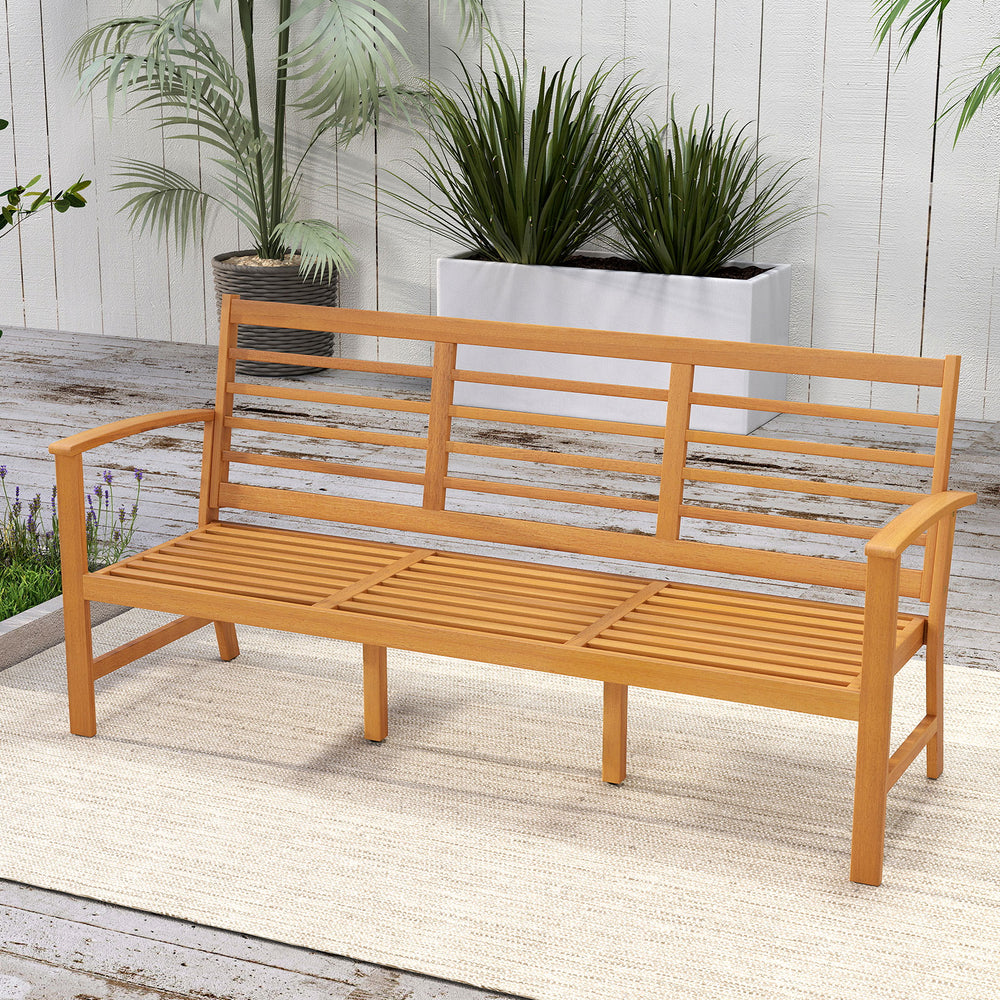 Patio 64-inch wood bench with slatted seat, made of acacia wood, ideal for backyard seating with comfortable cushion.