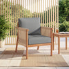 Acacia wood patio chair with gray cushions and woven rope armrests, perfect for backyard relaxation.