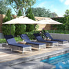 Four navy patio chaise lounge chairs with adjustable backrests, set up poolside for sunbathing and relaxation.