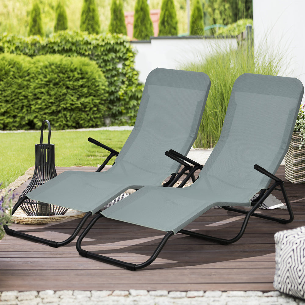 Two light green folding patio chaise loungers with rocking design, perfect for outdoor relaxation in the garden or.