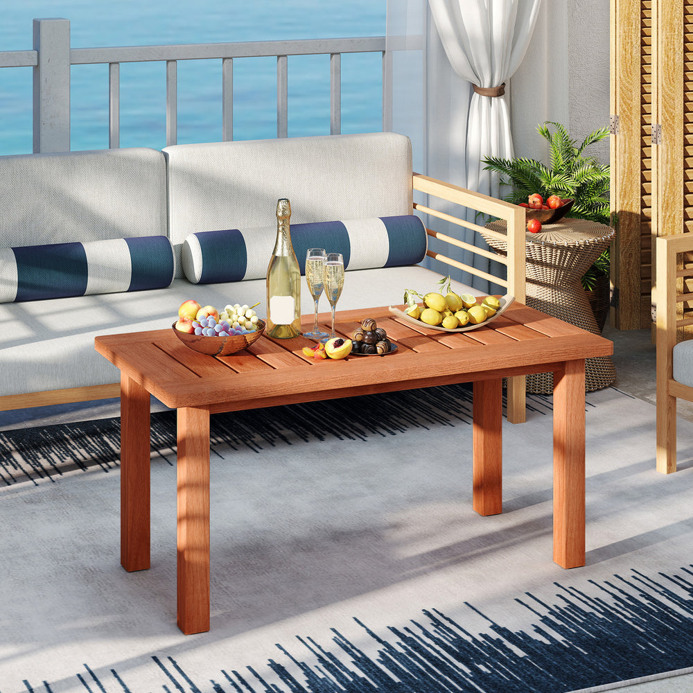 Patio coffee table with slatted wood design, showcasing drinks and fruits, perfect for outdoor gatherings on the deck.