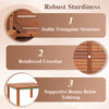 Patio coffee table with teak oil finish, featuring a slatted top, umbrella hole, and supportive beams for outdoor use.